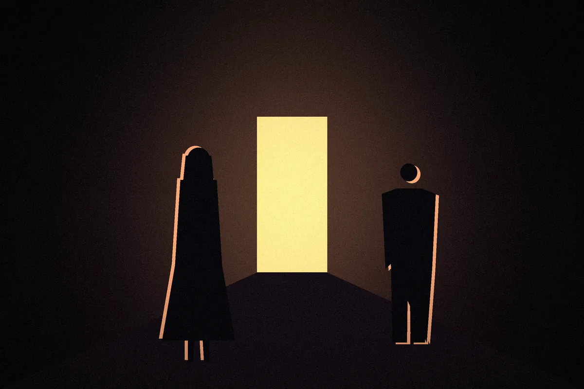Two figures face a bright open doorway at the end of a dark corridor.